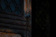 Opened rusty door with metal handle