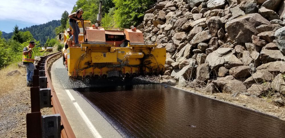 Asphalt paving machinery laying a road surface