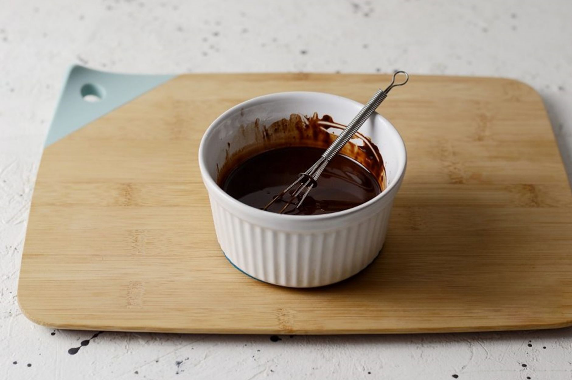 Caramelizing sugar topping on crme brle in mini ramekin with kitchen torch