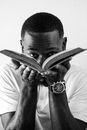 Black man opening book in hands