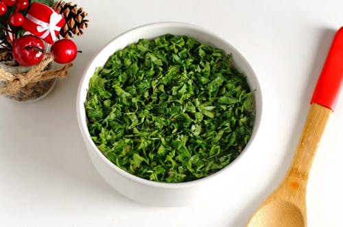 Chopped Green Leaves in White Ceramic Bowl