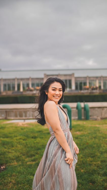 Woman in Blue Dress Standing on a Grass Field · Free Stock Photo