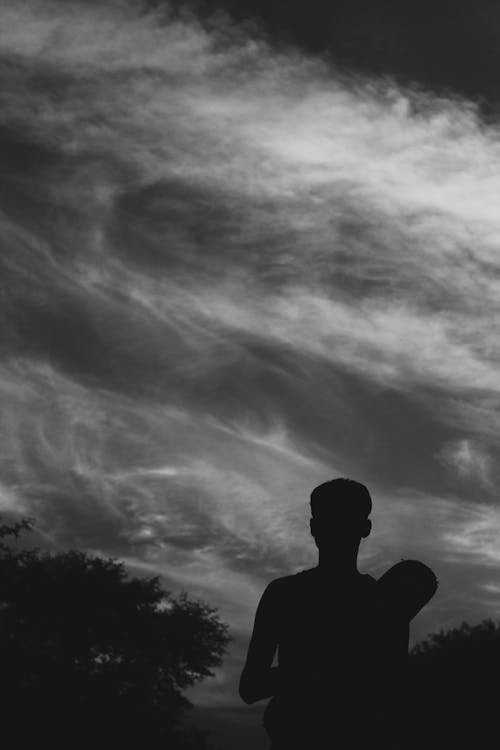 Silhouette of Man Against Cloudy Sky