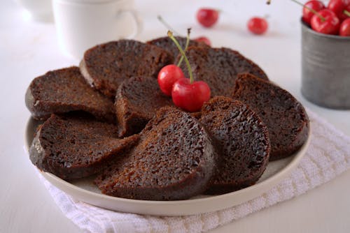 Free Chocolate Cake With Cherry on White Ceramic Plate Stock Photo