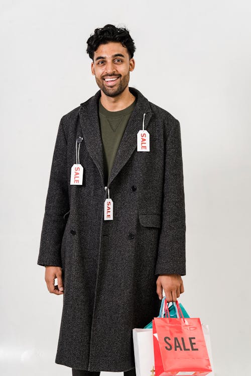 A Man Carrying Shopping Bags on Sale