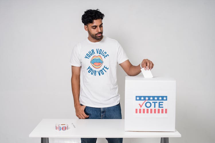 A Man Putting His Vote Inside The Box