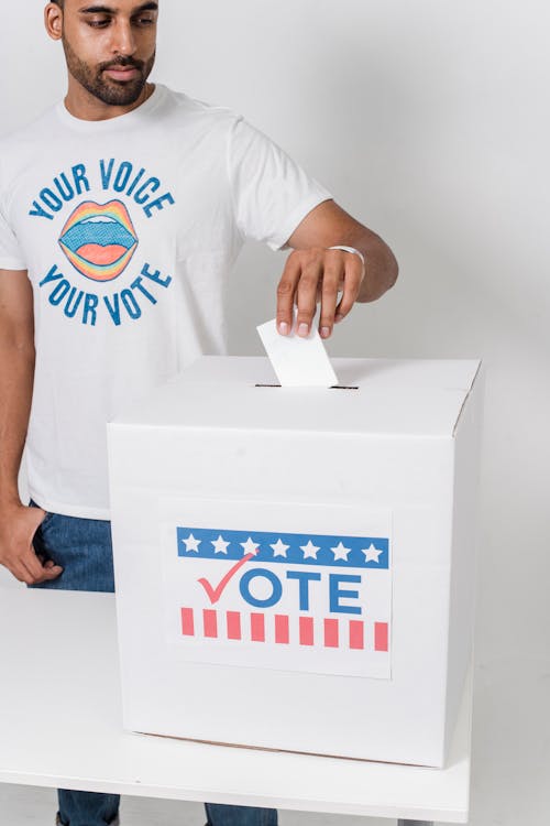 Photo Of Man Putting His Vote On The White Box