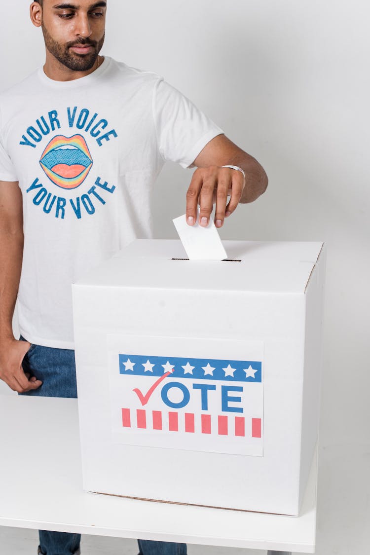 A Man Putting His Vote Inside The Box