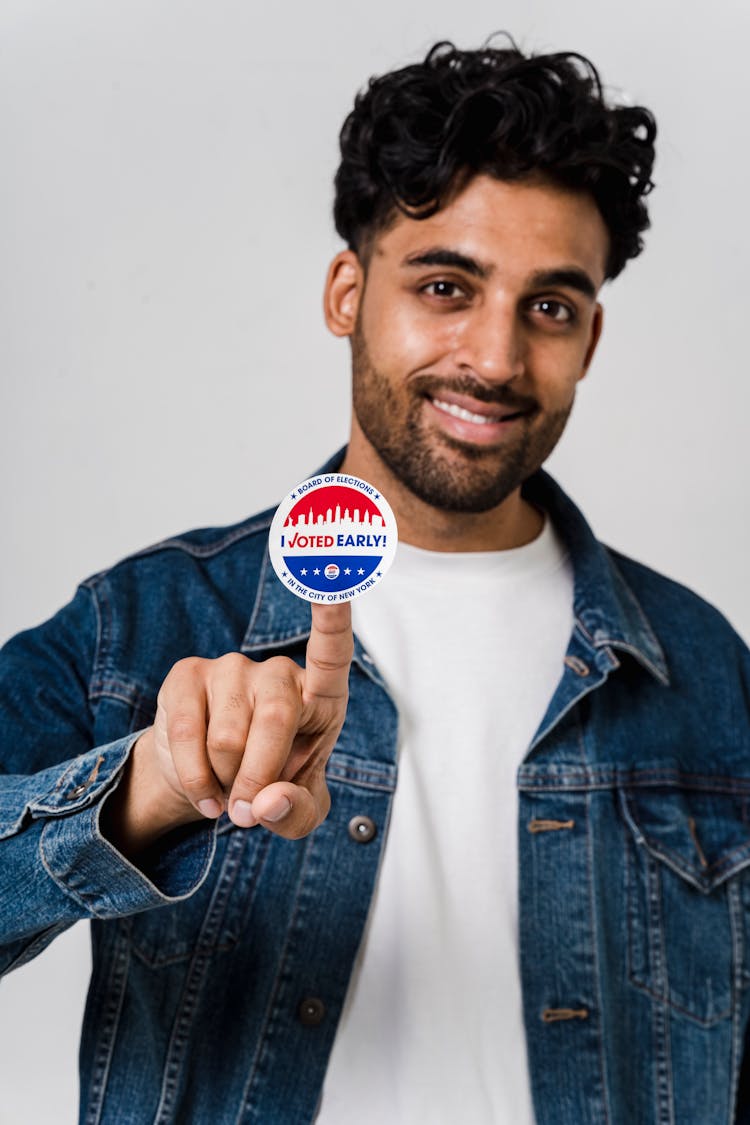 A Man With Round Sticker On His Finger