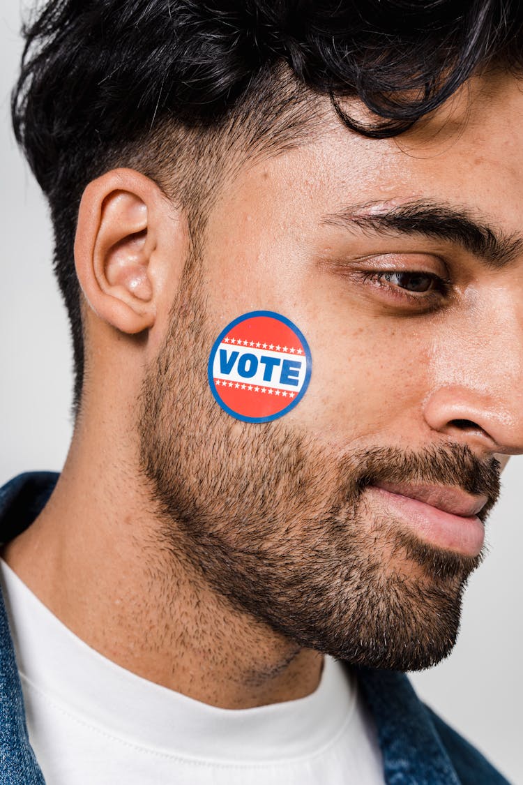 Vote Sticker On A Man's Face