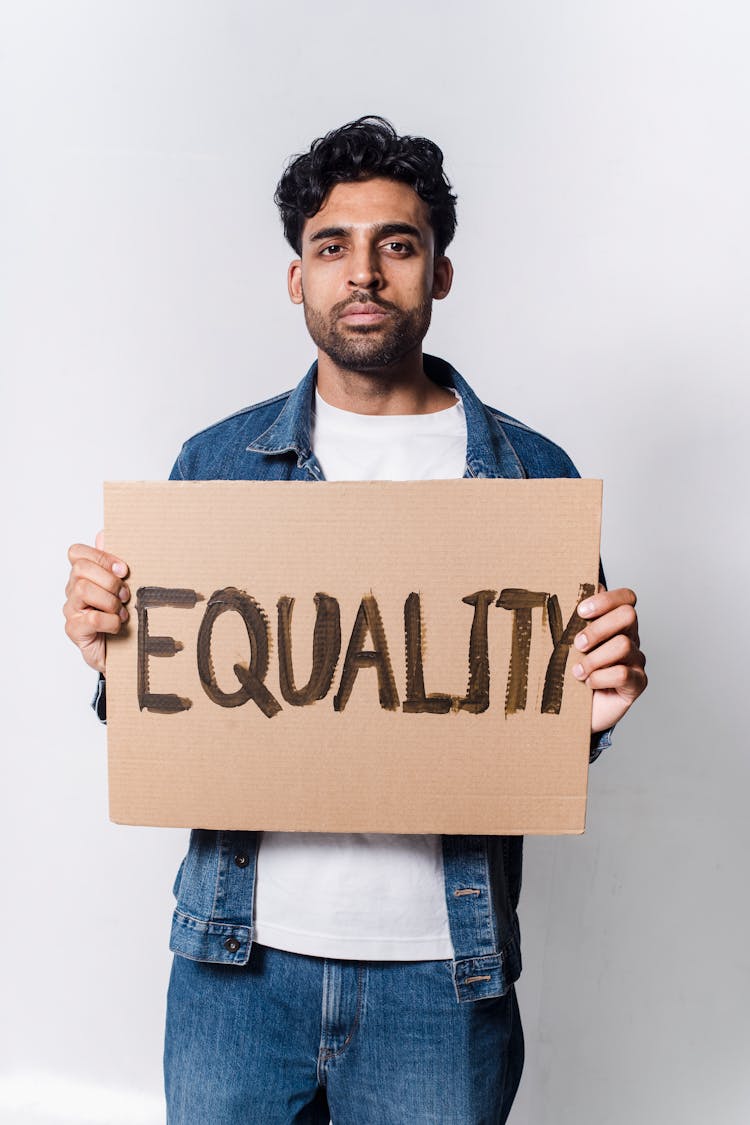 A Man Holding A Placard