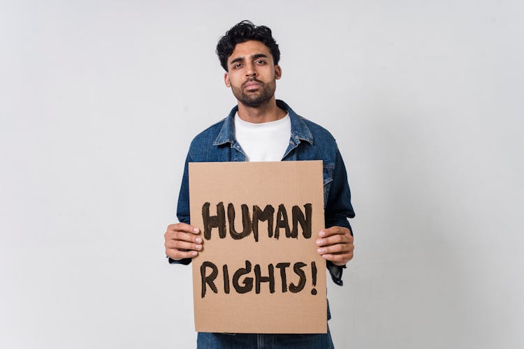 A Man Holding A Placard