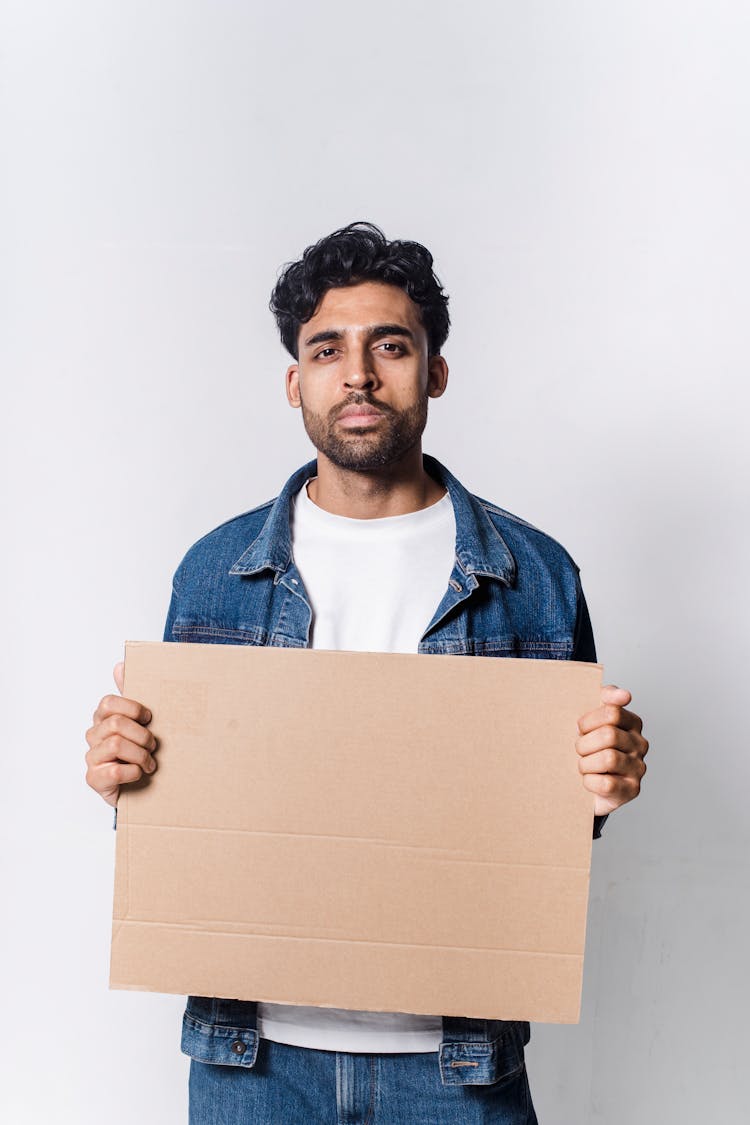 A Man Holding A Blank Placard