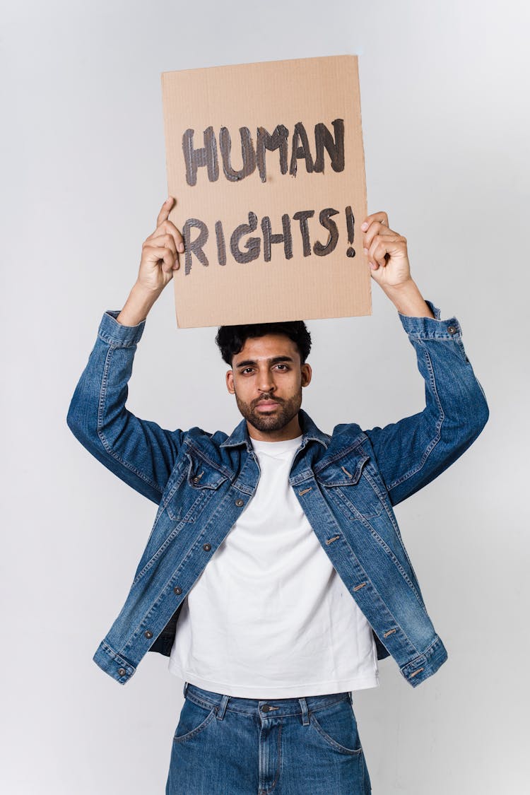 Man Holding Board With Script Human Rights