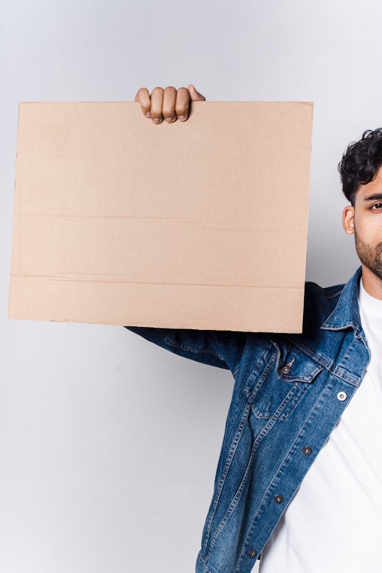 A Man Holding A Blank Cardboard