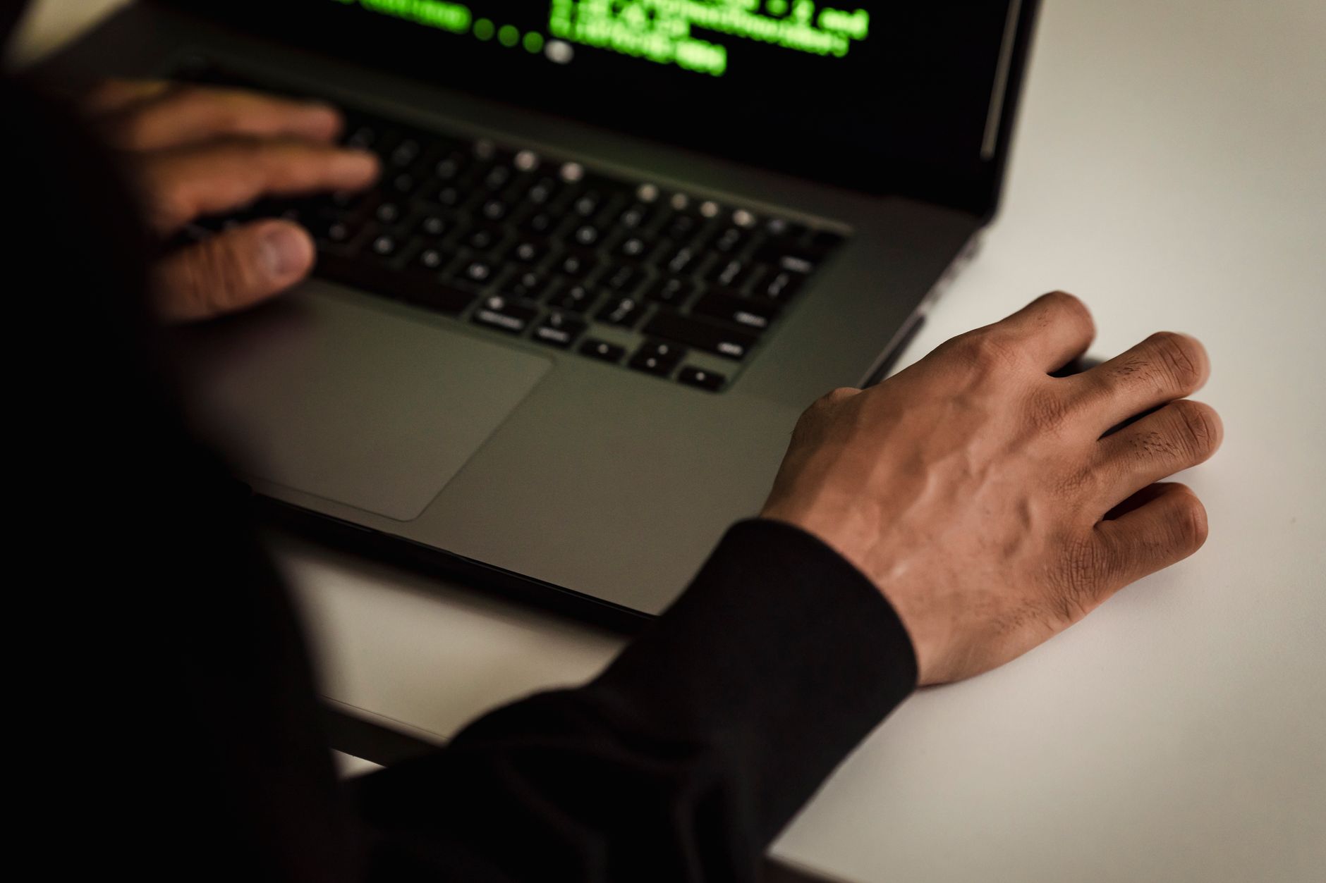 A developer working on a laptop while troubleshooting software issues.