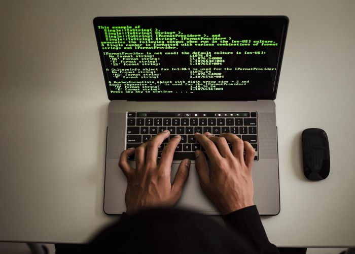 Developer working on a laptop, viewed from above