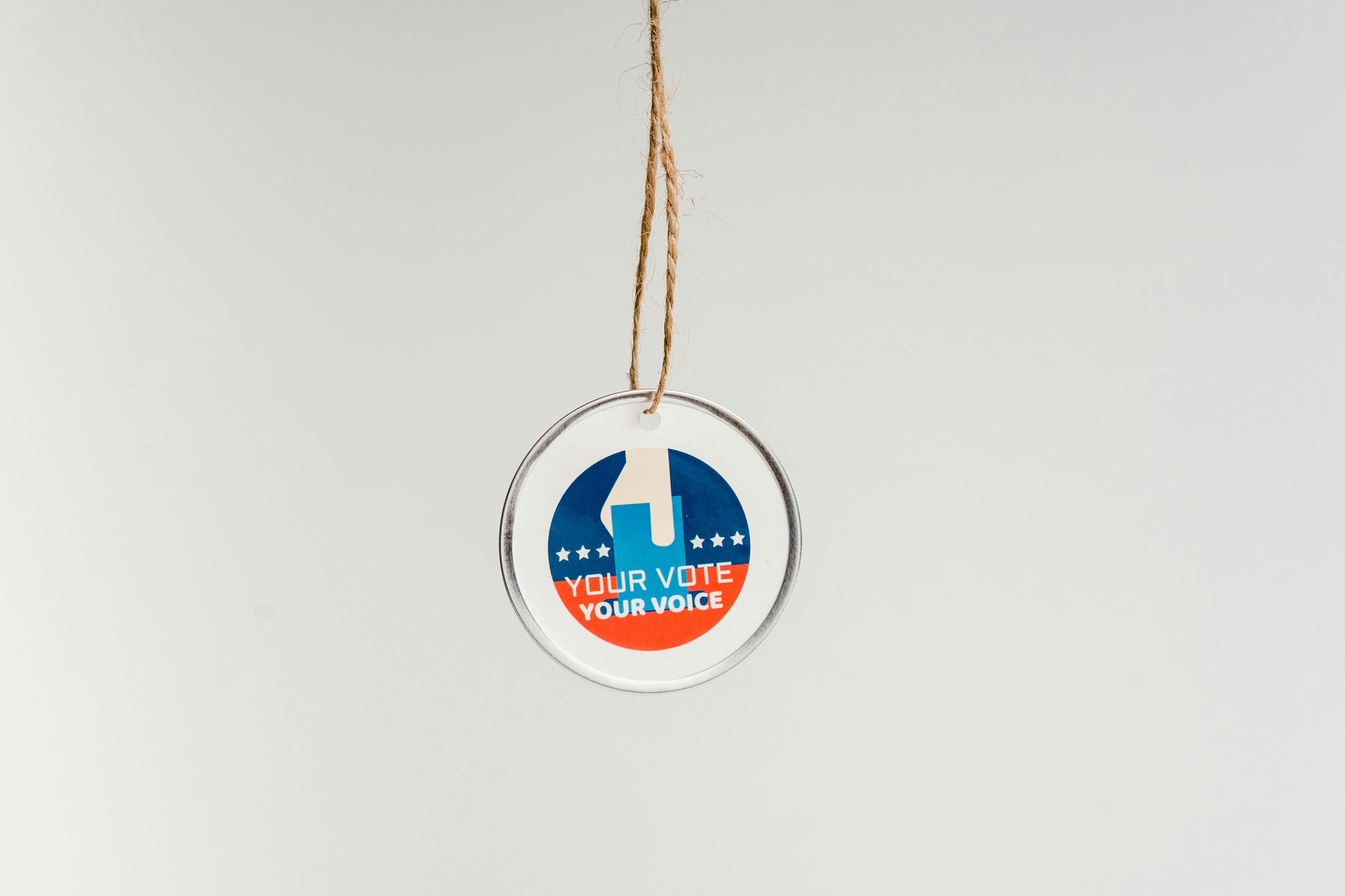 Close-up of a hanging ornament promoting voting with 'Your Vote Your Voice' text.