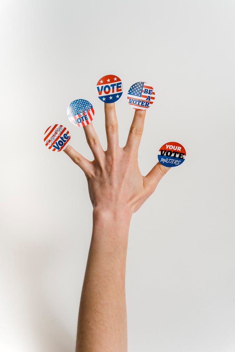 Hand With Vote Stickers On Fingers