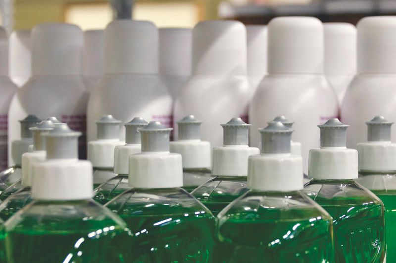 Close-up view of green liquid in bottles, ideal for household cleaning and stocks.