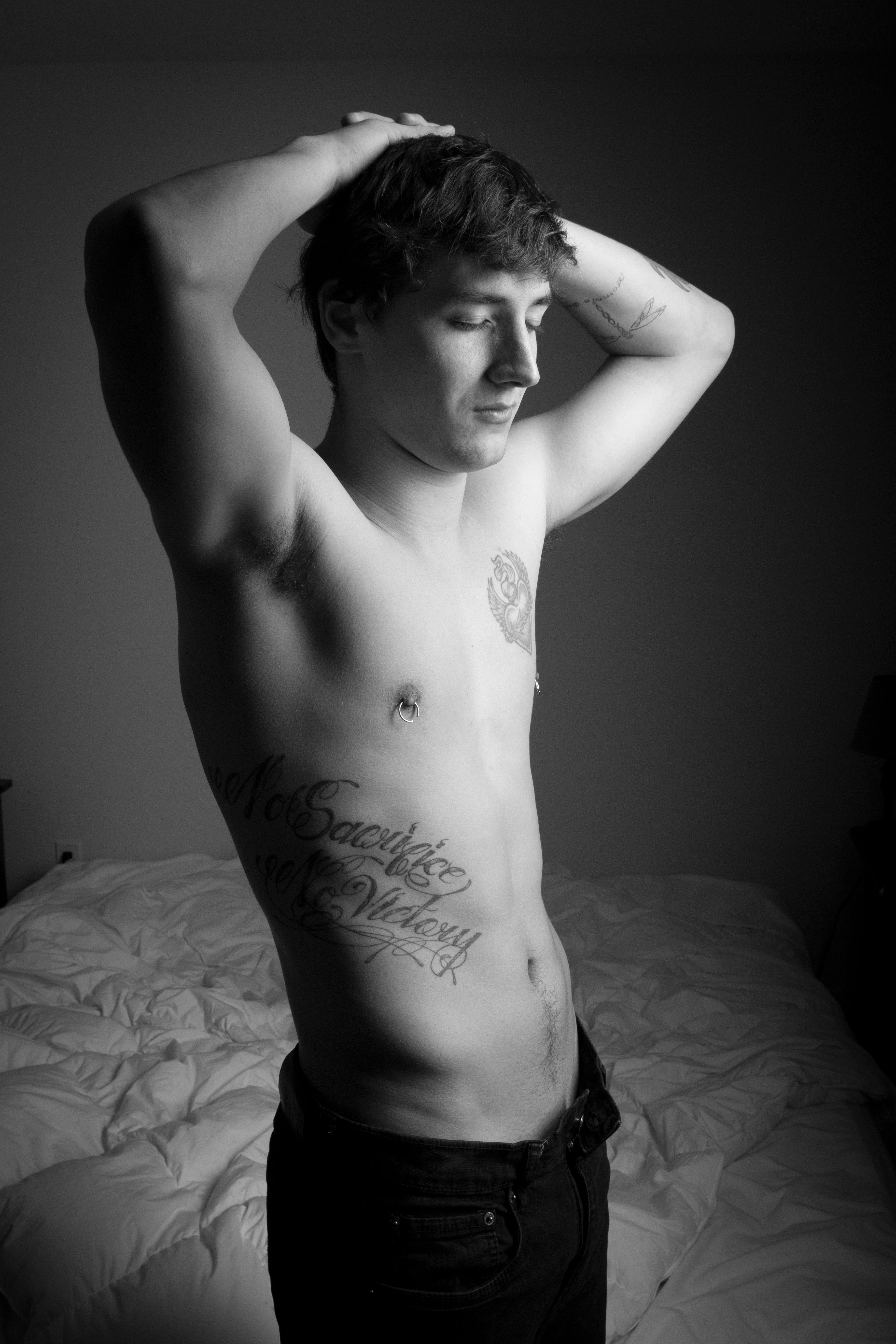 man with chest and rib tattoo
