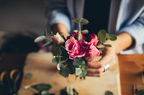 Person Holding A Bunch of Pink Flowers