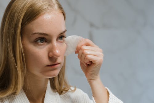 Free Blonde Woman Massaging Her Face With Gua Sha Stock Photo