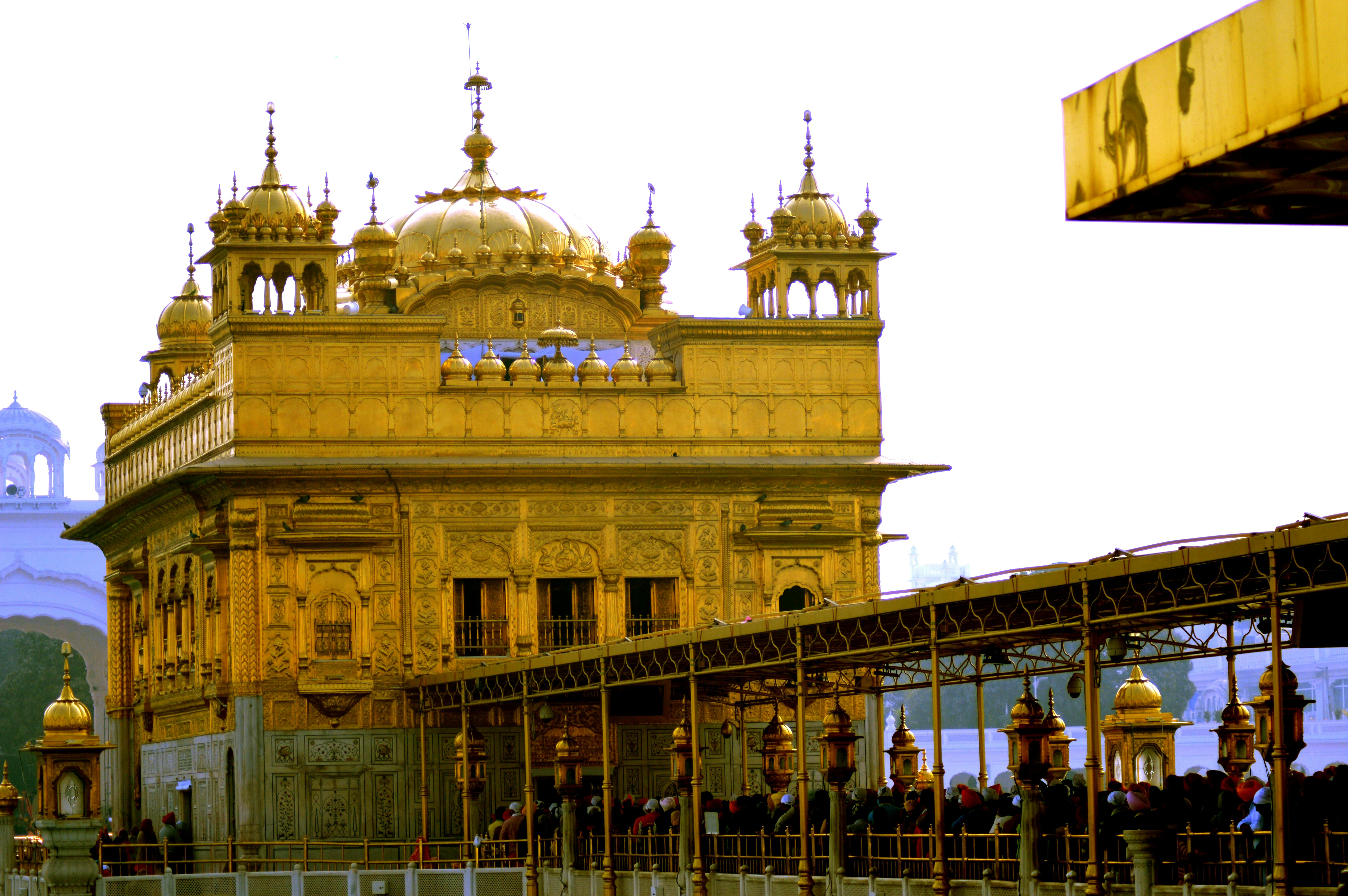 Person resting on a couch looking fatigued, holding their head in their hand