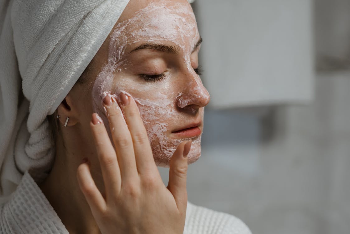 Woman in White Knit Shirt Covering Her Face With White Textile