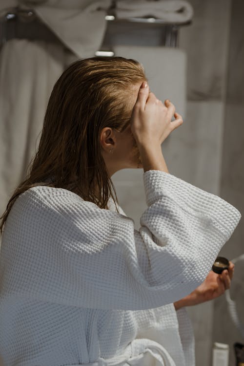 Free Woman in White Bathrobe Applying Coffee Scrub On Face Stock Photo