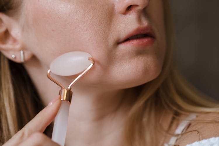 A Woman Using White Jade Roller