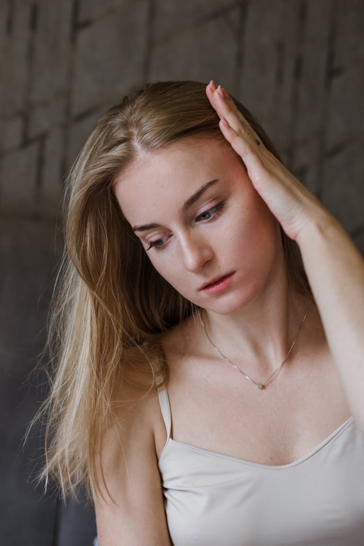 Woman In Spaghetti Strap Holding Hair Away From Face