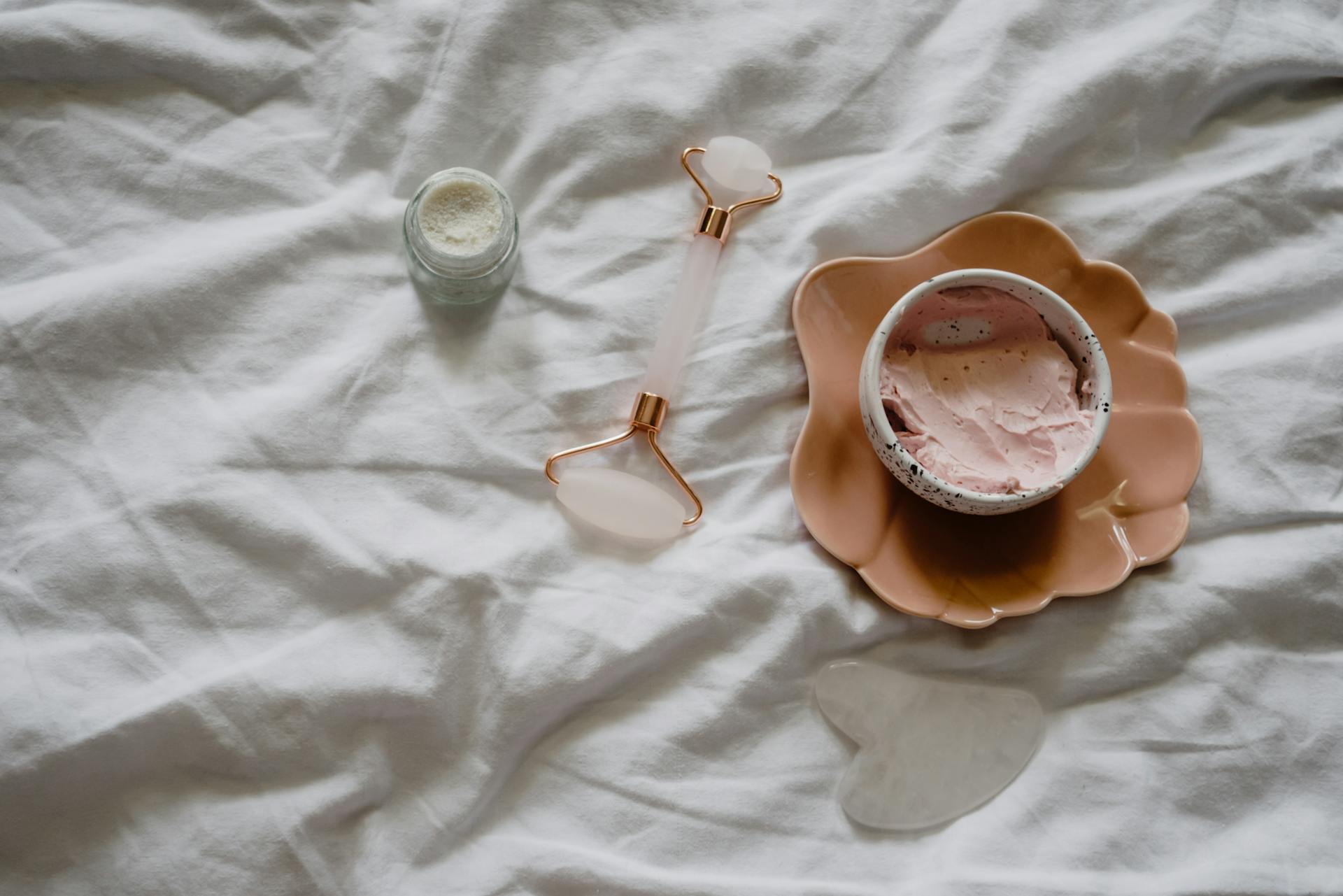 A flat lay of skincare tools and products for a rejuvenating beauty routine.