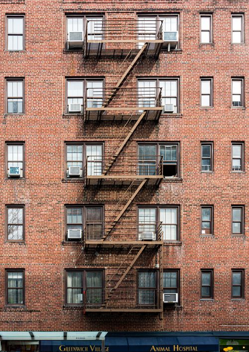 Free Brick facade with fire escapes in Greenwich Village, NYC. Stock Photo