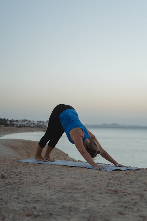 A Woman Doing Yoga at the Beach 