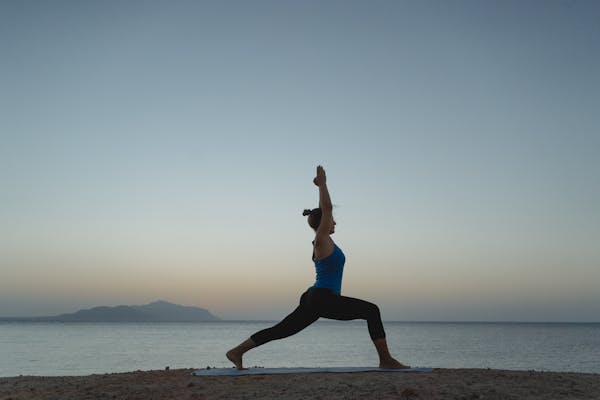 Yoga practice on the shore at first light. Photo by Tima Miroshnichenko on Pexels