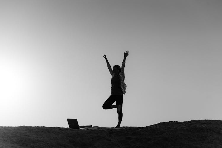 Woman Exercising On Hilltop