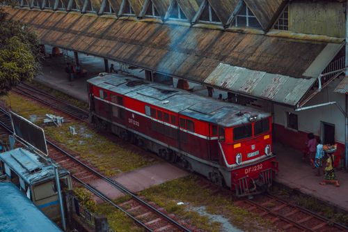Free A red train captured at Yangon Railway Station with a classic, vintage vibe, showcasing local life. Stock Photo