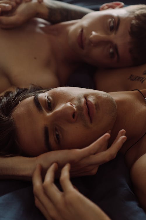 Free Gay Couple Lying Together in Bed  Stock Photo