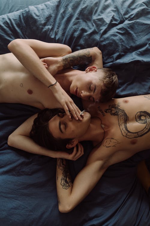 Topless Man Lying on Bed Beside Woman