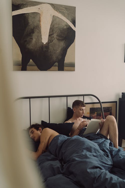 Gay Couple Lying Together in Bed 