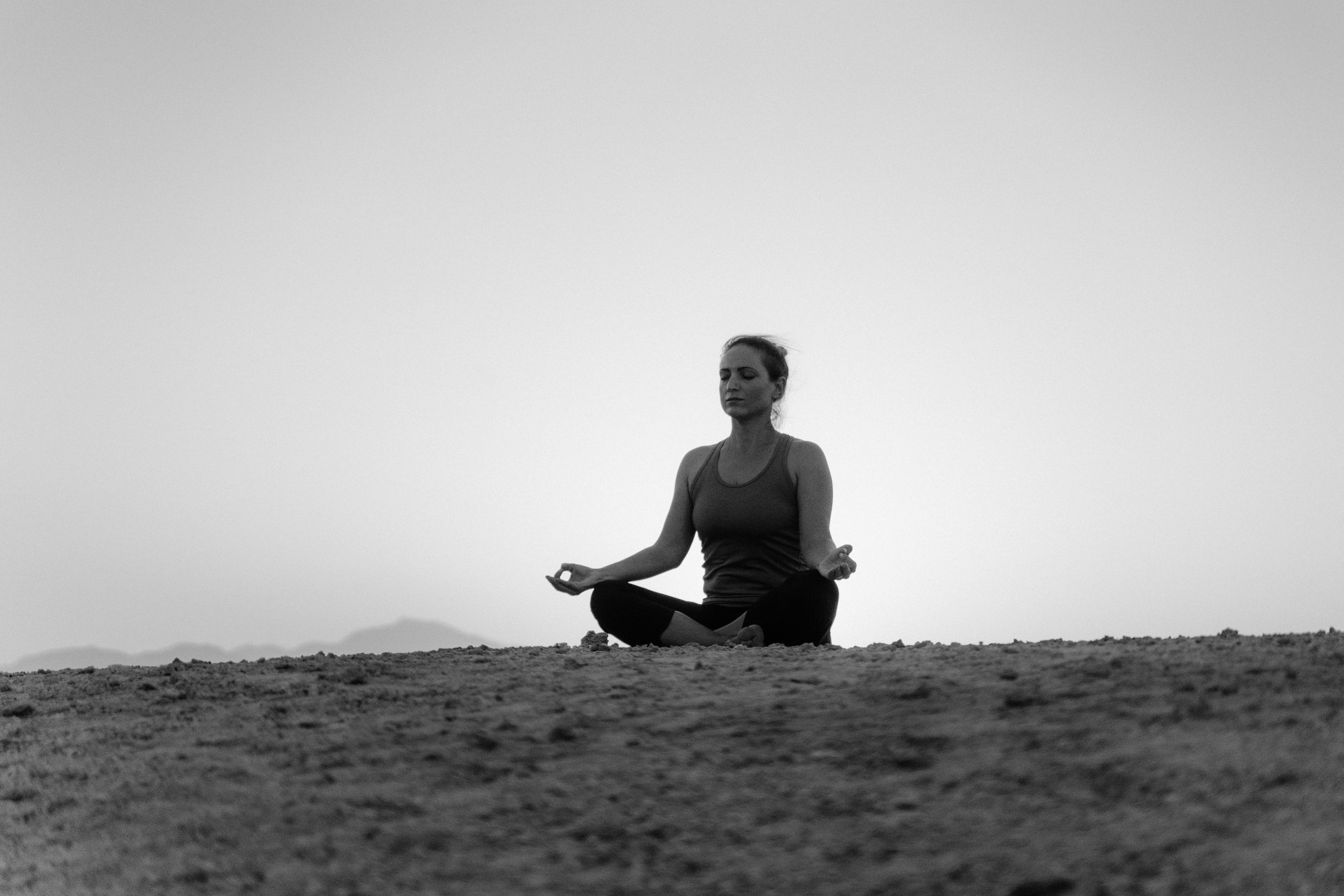 woman in black tank top sitting on ground