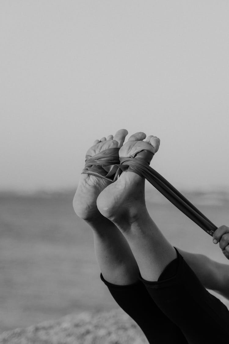 Monochrome Shot Of A Person's Feet Tied With Resistance Band