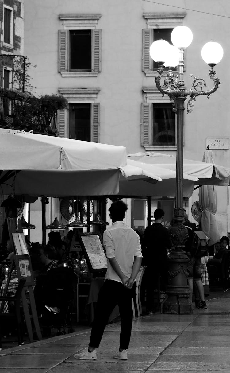 People Under Umbrellas In A Restaurant Patio 