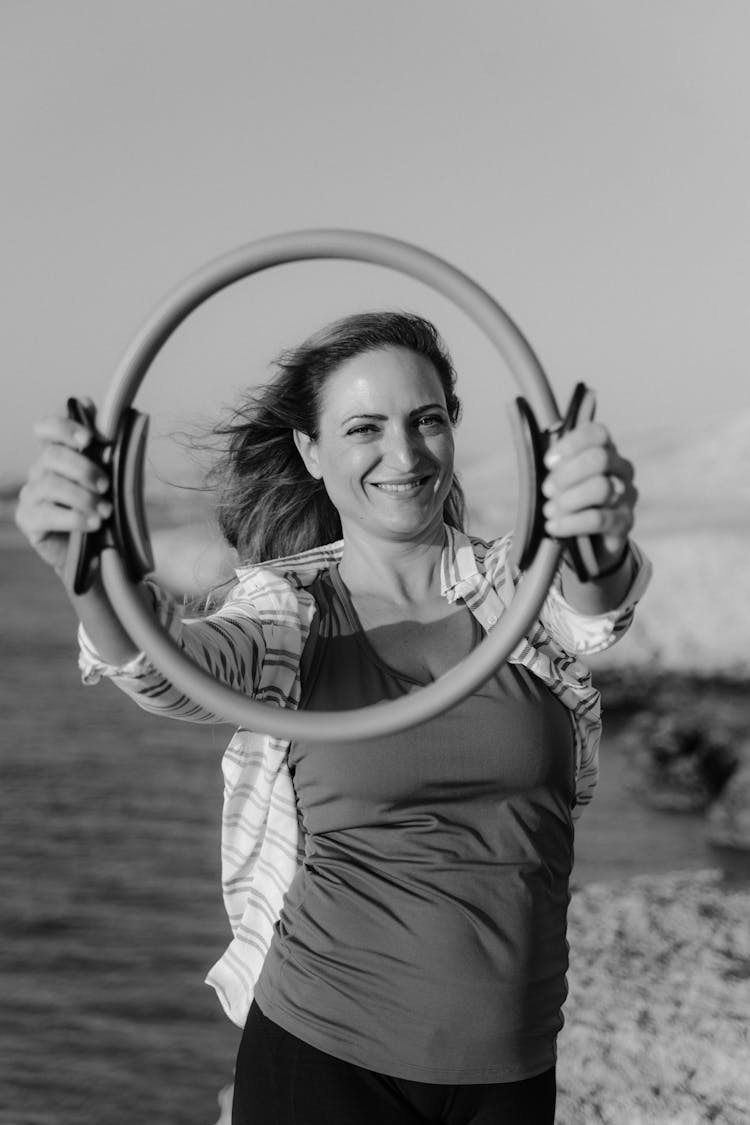 A Woman Holding A Pilates Ring