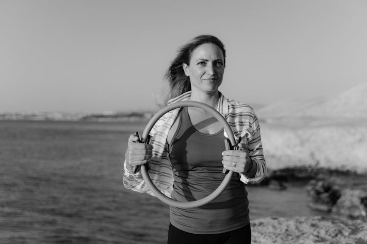 A Woman Holding A Pilates Ring