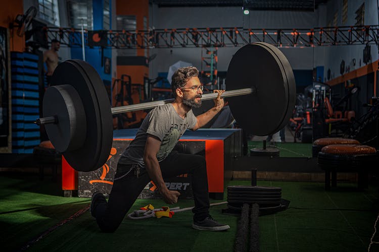 Man In Gray Shirt Lifting A Barbell 