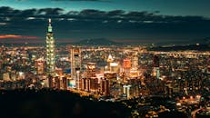 Cityscape with illuminated buildings and skyscrapers at night