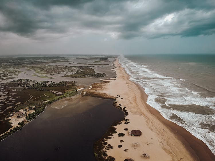 Cloudy Sky Over Land And Sea