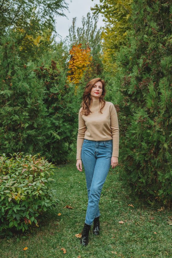 Woman in belted jeans outfit with boots